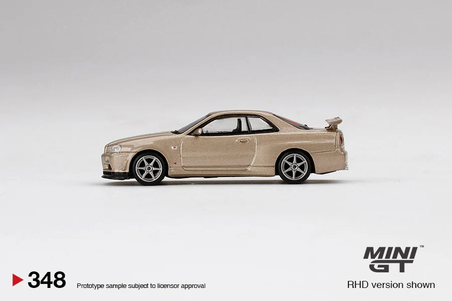 NISSAN SKYLINE GT-R (R34) M-SPEC (SILICA BREATH GOLD) MINI GT 1:64